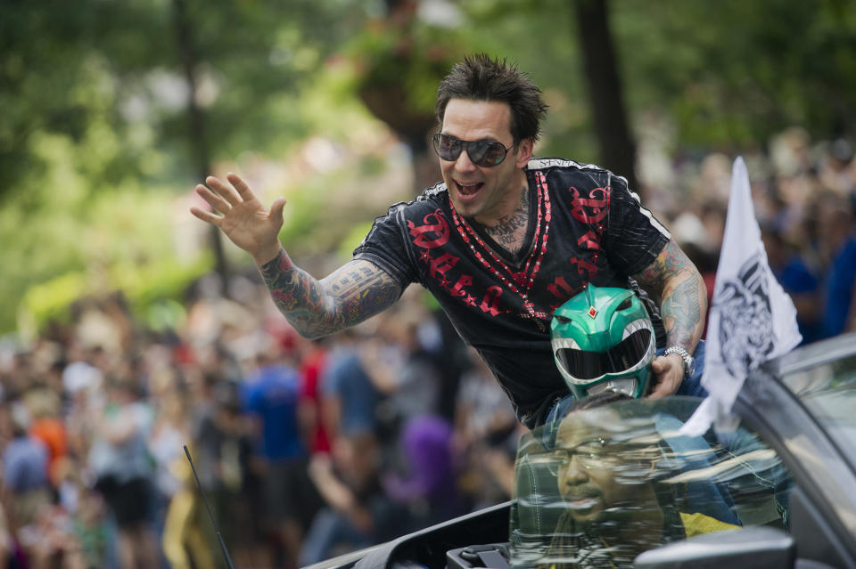 FILE - Jason David Frank waves to the crowd as he makes his way down Peachtree Street in the annual DragonCon parade through downtown Atlanta, on Aug. 31, 2013. Frank, who played the Green Power Ranger Tommy Oliver on the 1990s children's series “Mighty Morphin Power Rangers," has died, according to a statement Sunday, Nov. 20, 2022, from his manager, Justine Hunt. He was 49. (Jonathan Phillips/Atlanta Journal-Constitution via AP, File)