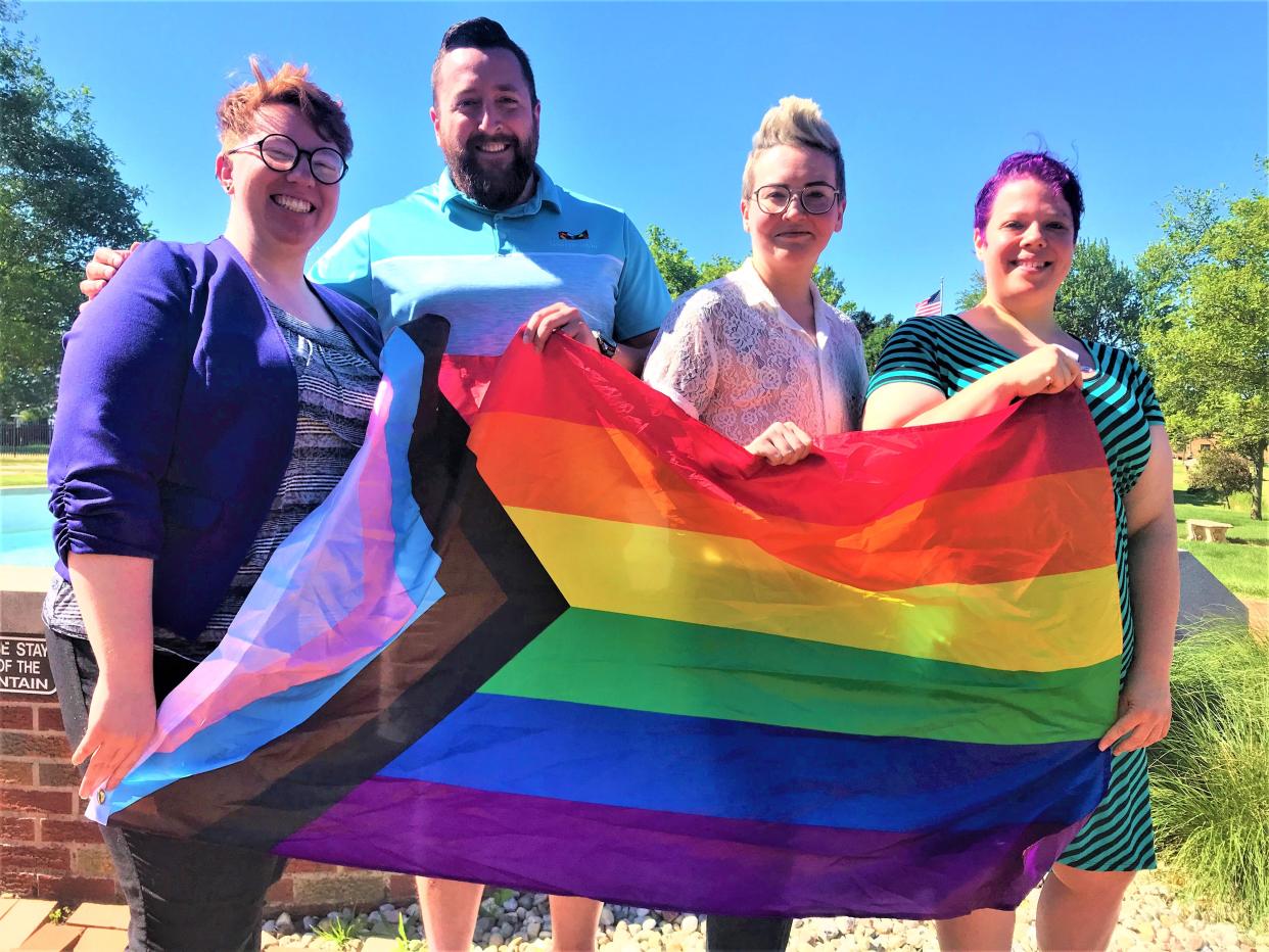 Fremont Pride 2022 organizers from left, Jozie Hickman, Tyler Kneeskern, Stevie Keck and Nicole Russell stand with a pride flag in front of Walsh Park's fountain in Fremont. The 2nd Annual Fremont Pride Festival will be held July 9 at Walsh Park from 12 to 9 p.m., with a parade preceding the festival at 11 a.m. on S. Front Street in downtown Fremont.