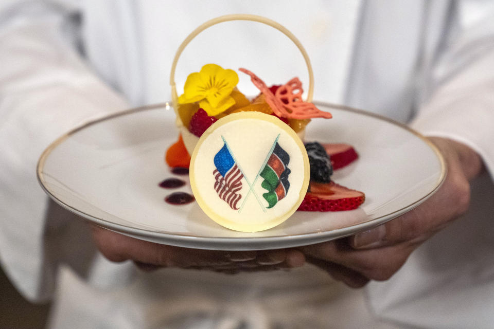 White House Executive Pastry Chef Susie Morrison holds a dessert of a white chocolate basket with banana ganache, raspberries, peaches, and candied lime zest, during a preview of the State Dinner with Kenya, Wednesday, May 22, 2024, at the White House in Washington. (AP Photo/Jacquelyn Martin)
