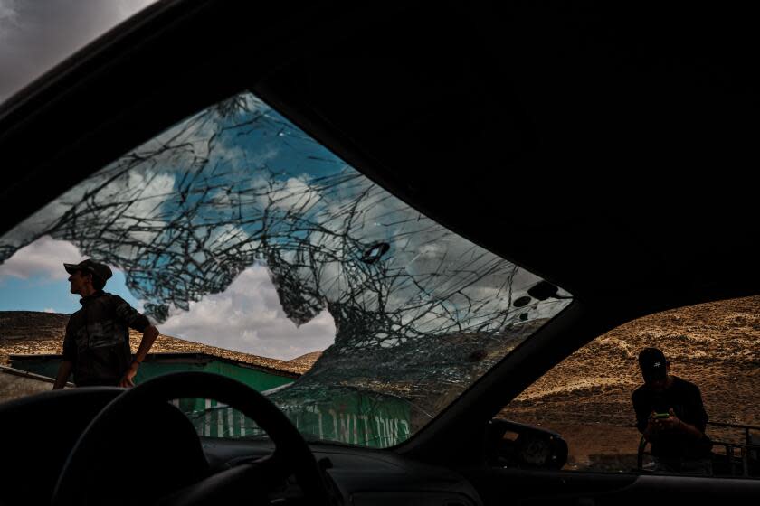 WADI TIRAN, OCCUPIED WEST BANK -- NOVEMBER 15, 2023: Palestinian boys inspect the windshield of vehicle that was damaged by settlers who trespassed onto their farm and stoned it, in Wadi Tiran, Occupied West Bank, Wednesday, Nov. 15, 2023. IsraelÕs war against Hamas in Gaza has intensified the settler movement in the Israeli occupied West Bank, where for decades Jewish enclaves have risen from strategic high grounds to prevent an independent Palestinian state. About 500,000 settlers, with the help of army and police, essentially have free rein amid 2.7 million Palestinians. Nearly 1,000 Palestinians have fled West Bank villages and small communities in recent weeks after settlers demolished and burned homes, destroyed olive trees, blocked roads, and cut off electricity and water, according to BÕTselem, an Israeli human rights group. Much of the harassment and violence reverberate through Area C, which covers about 60 percent of the West Bank and is home to about 130 Jewish settlements and 100 outposts. The region is administered by the autonomous Palestinian Authority but controlled by Israeli forces. The Jewish settlements Ð Palestinians face restrictions on developing land Ð are considered by most nations an illegal Israeli design to annex territory in the Jordan Valley and Judean Desert. (MARCUS YAM / LOS ANGELES TIMES)