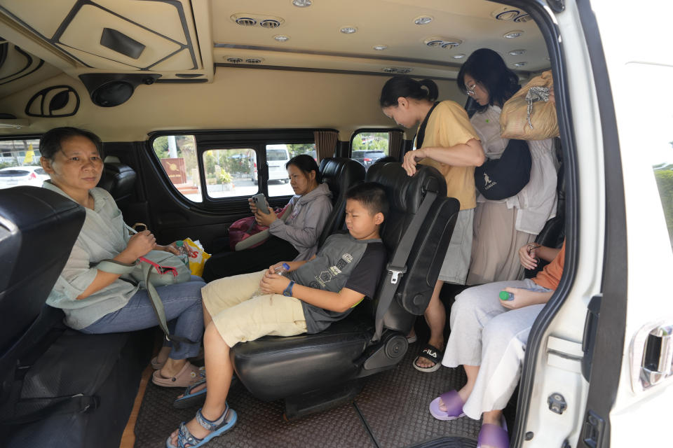 Members of the Shenzhen Holy Reformed Church, also known as the Mayflower Church, leave from the Nongprue police station on their way to Pattaya Provincial Court in Pattaya, Thailand, Friday, March 31, 2023. More than 60 members of a Chinese Christian church have been detained in Thailand, supporters said Friday, raising fears they may be returned to their home country, where they face possible persecution. (AP Photo/Sakchai Lalit)