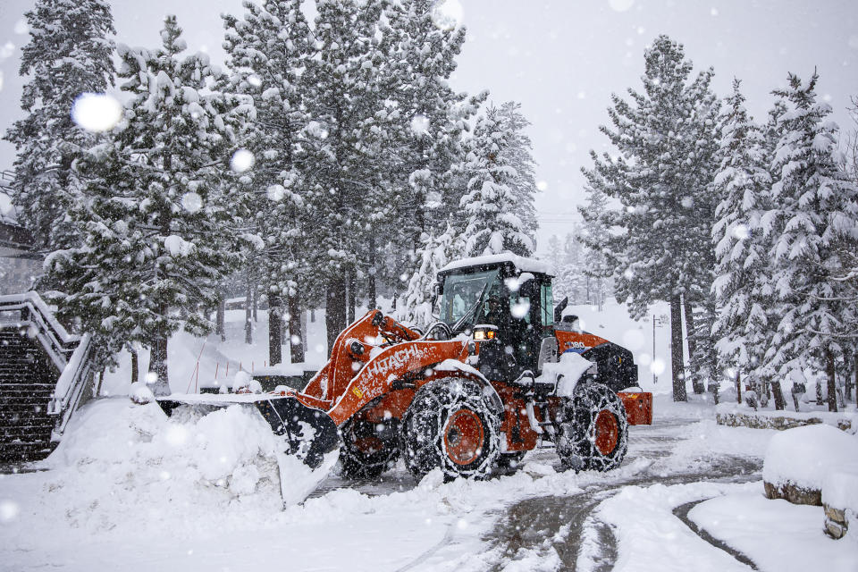 In this photo provided by the Mammoth Mountain Ski Area, a snow plow clears a road in Mammoth Lakes, Calif., on Thursday, Feb. 1, 2024. (Samantha Lindberg/Mammoth Mountain Ski Area via AP)
