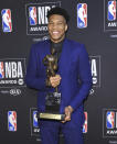 NBA player Giannis Antetokounmpo, of the Milwaukee Bucks, poses in the press room with most valuable player award at the NBA Awards on Monday, June 24, 2019, at the Barker Hangar in Santa Monica, Calif. (Photo by Richard Shotwell/Invision/AP)