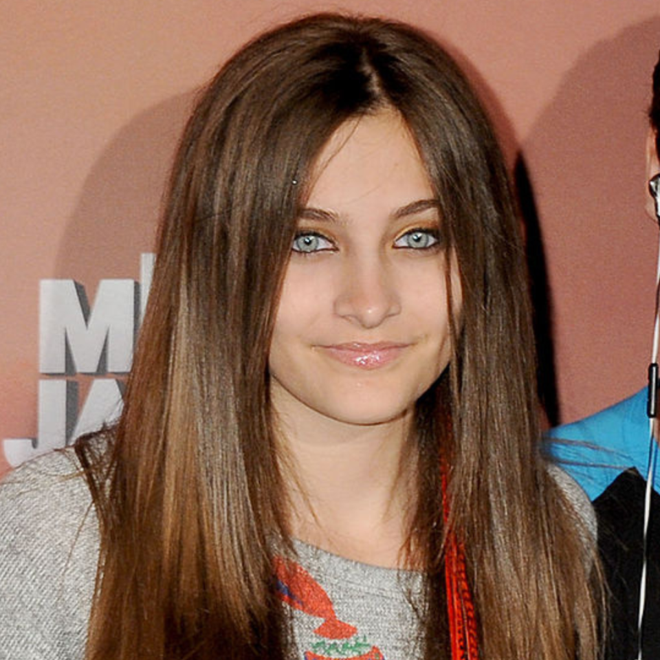 Portrait of Paris Jackson with straight hair and glossy lips, partial view of another person on right side