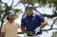 Patrick Reed watches his tee shot as Tommy Fleetwood, of England, left waits to hit on the seventh tee during the second round of the PGA Championship golf tournament on the Ocean Course Friday, May 21, 2021, in Kiawah Island, S.C. (AP Photo/Chris Carlson)