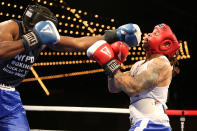 <p>Jamaal Spence lands a left on Emmanuel Etienne during the NYPD Boxing Championships at the Theater at Madison Square Garden on June 8, 2017. (Photo: Gordon Donovan/Yahoo News) </p>