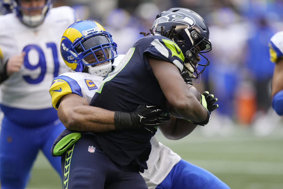 Seattle Seahawks running back DeeJay Dallas, right, is tackled by Los Angeles Rams linebacker Bobby Wagner during the first half of an NFL football game Sunday, Jan. 8, 2023, in Seattle. (AP Photo/Stephen Brashear)