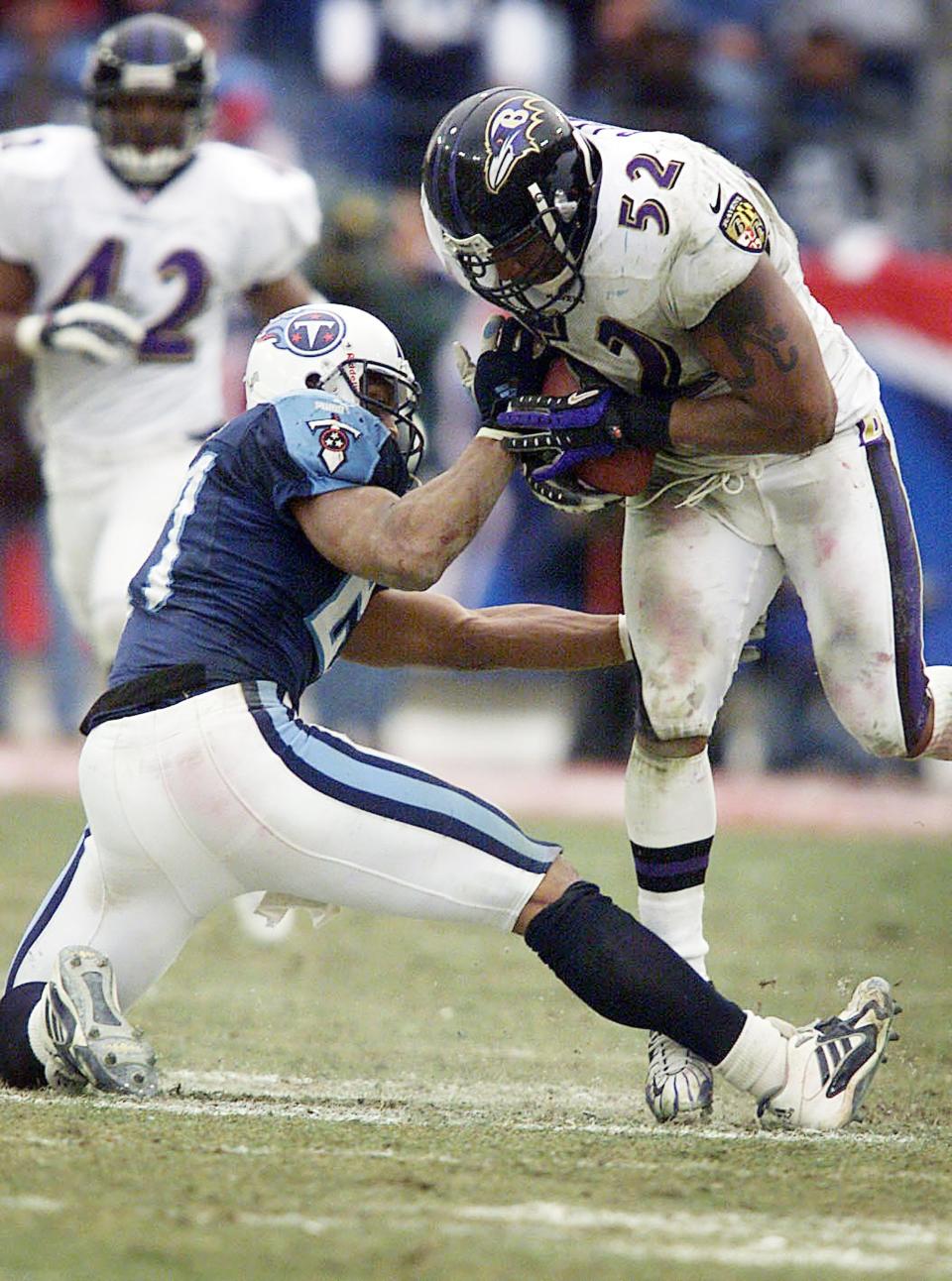 Tennessee Titans running back Eddie George, left, has the ball stripped from his hands by Baltimore Ravens linebacker Ray Lewis (52), who returned it for a touchdown during the AFC Divisional Round playoff game at Adelphia Coliseum Jan. 7, 2001.