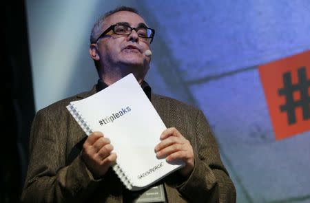 Juergen Knirsch of the environmental campaign group Greenpeace holds a copy of the leaked TTIP negotiations during a news conference in Berlin, Germany, May 2, 2016. REUTERS/Fabrizio Bensch