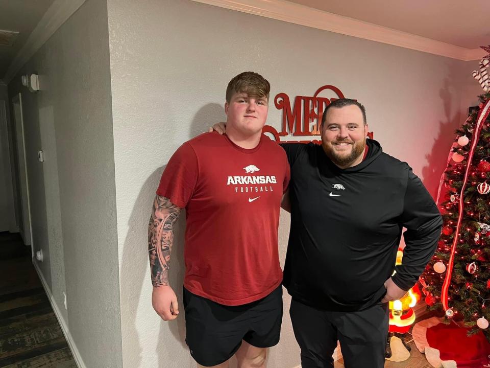 Arkansas football commit Kobe Branham (left) stands with new offensive line coach Eric Mateos during a recent in-home visit. Branham will sign with the Razorbacks Wednesday at Fort Smith's Evans Boys and Girls Club.