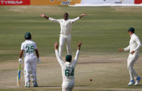 South Africa's Lungi Ngidi, top center, and his teammates appeal an unsuccessful LBW out of Pakistan's batsman Mohammad Rizwan during the second day of the first cricket test match between Pakistan and South Africa at the National Stadium, in Karachi, Pakistan, Wednesday, Jan. 27, 2021. (AP Photo/Anjum Naveed)