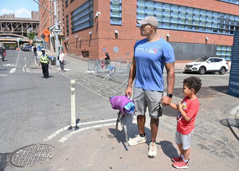 Kenny U. Grant and son Hudson, 4, outside the Peck Slip School, P.S. 343, where his son is a student. Helayne Seidman