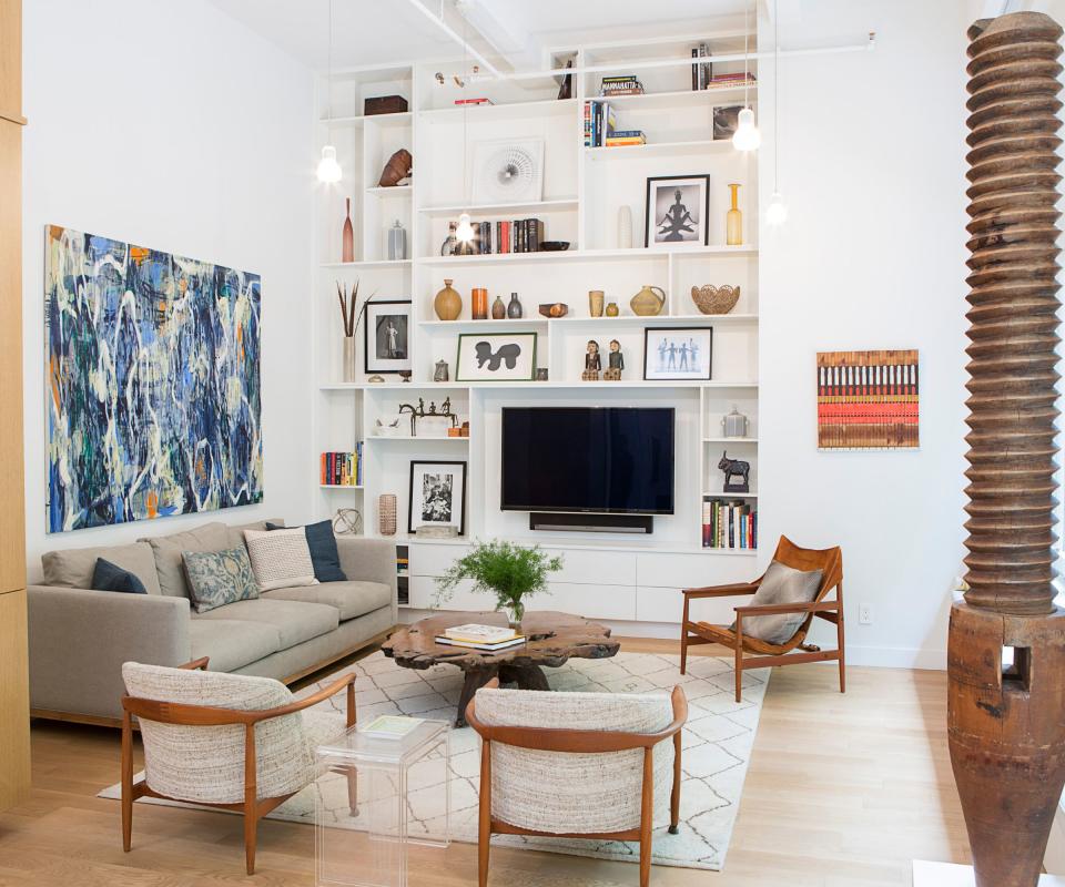 Living room in white apartment with TV in central unit