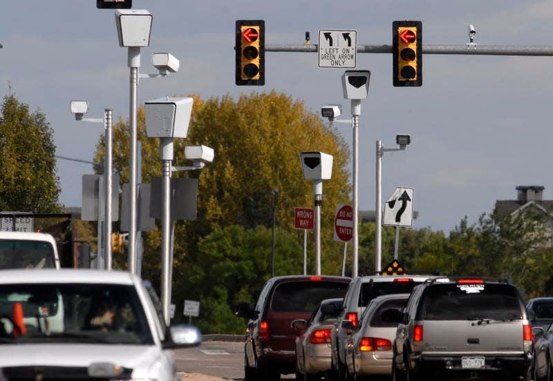 In this file photo, red-light cameras stand on the east and west ends of the intersection of Harmony Road and Timberline Road.