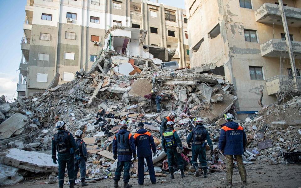 Russian rescue personnel search for survivors and victims under the rubble of a collapsed building in the town of Jableh in Syria's northwestern province of Latakia - AFP via Getty Images