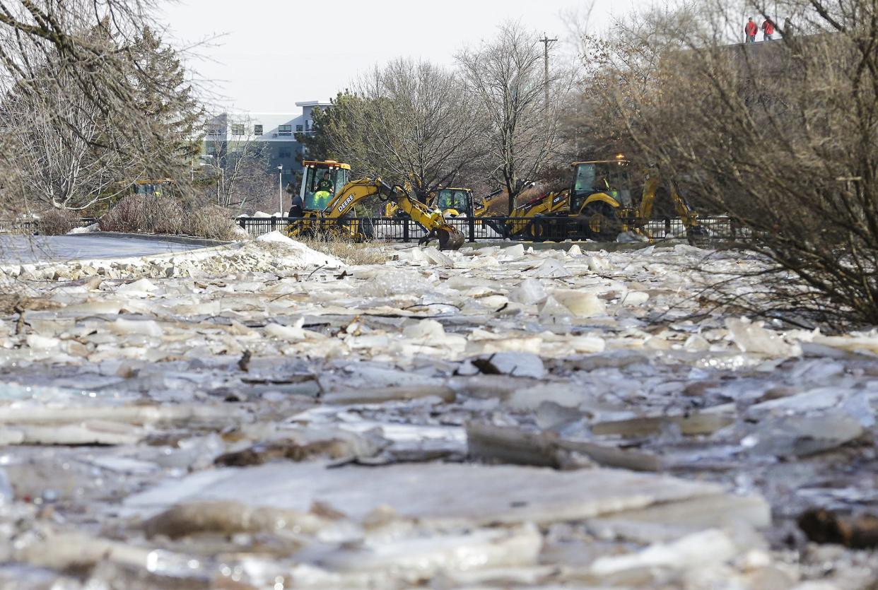 Fond du Lac Department of Public Works members use back hoes Thursday, March 14, 2019, to clear ice jams along the Fond du Lac River in Fond du Lac, Wis. Ice jams on the east branch of the Fond du Lac River caused localized flooding problems in the city.