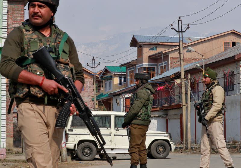 Indian security forces stand guard at the site of a grenade explosion in Srinagar