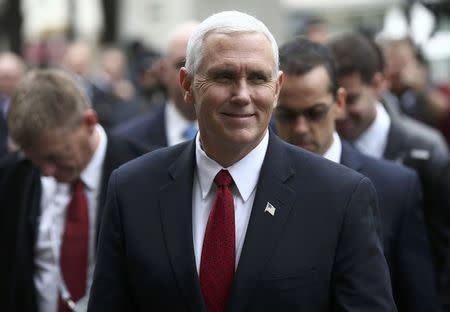 U.S. Vice President Mike Pence walks with members of his delegation ahead of bilateral talks during the 53rd Munich Security Conference in Munich, Germany, February 18, 2017. REUTERS/Michael Dalder