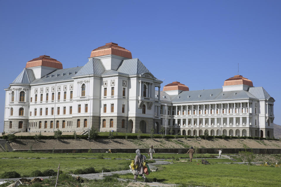 Afghans work in the garden of the renovated Darul Aman Palace in Kabul, Afghanistan, Wednesday, April 24, 2024. (AP Photo/Siddiqullah Alizai)