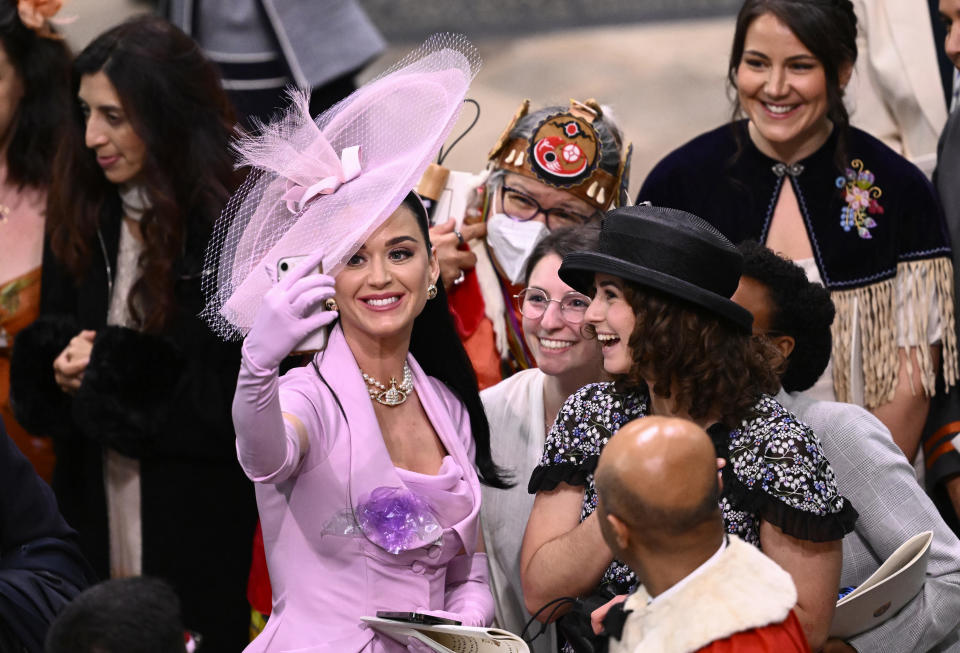LONDON, ENGLAND - MAY 06: Katy Perry takes selfies with guests during the Coronation of King Charles III and Queen Camilla on May 06, 2023 in London, England. The Coronation of Charles III and his wife, Camilla, as King and Queen of the United Kingdom of Great Britain and Northern Ireland, and the other Commonwealth realms takes place at Westminster Abbey today. Charles acceded to the throne on 8 September 2022, upon the death of his mother, Elizabeth II. (Photo by Gareth Cattermole/Getty Images)