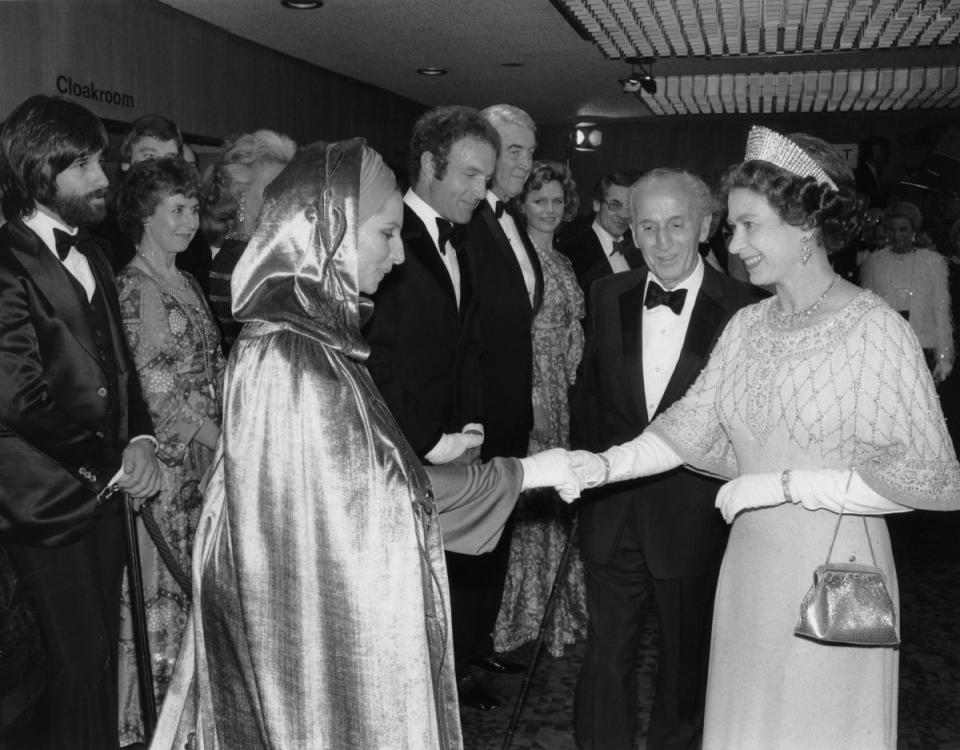 Barba Streisand: The monarch smiles as she meets Barbra Streisand at the London premiere of <i>Funny Lady</i>, March 1975 (Rex Features)