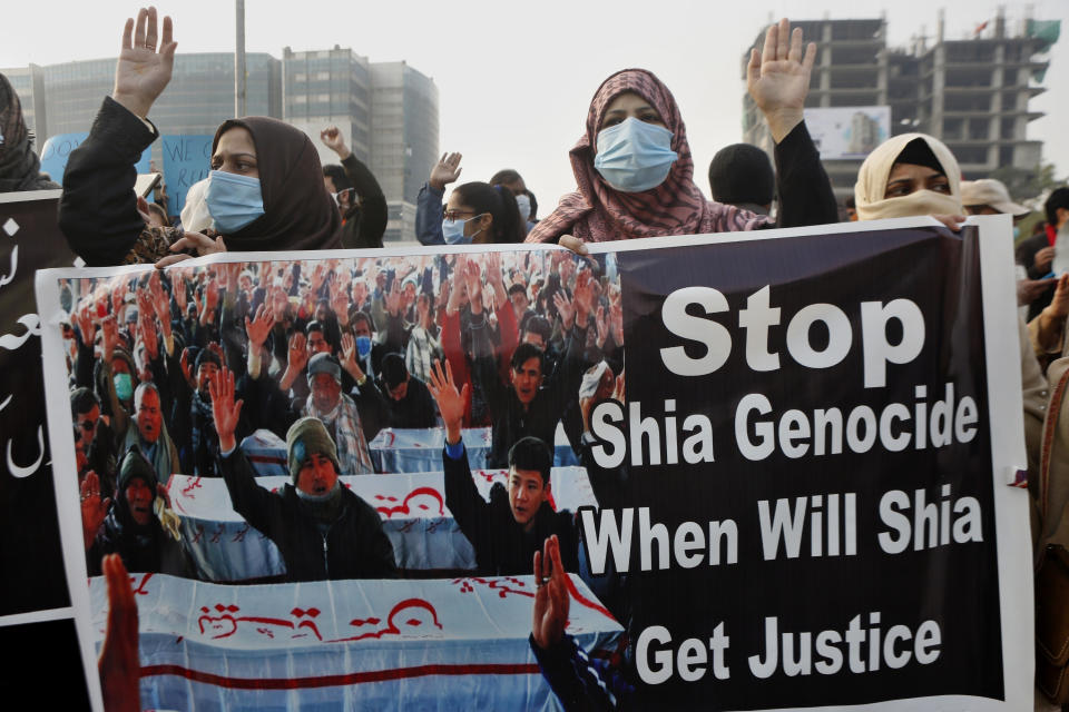 Supporters of a civil society organization hold a demonstration to protest the killing of coal mine workers by gunmen near the Machh coal field, in Lahore, Pakistan, Thursday, Jan. 7, 2021. Pakistan's minority Shiites continued their sit-in for a fifth straight day insisting they will bury their dead only when Prime Minister Imran Khan personally visits them to assure protection. (AP Photo/K.M. Chaudary)