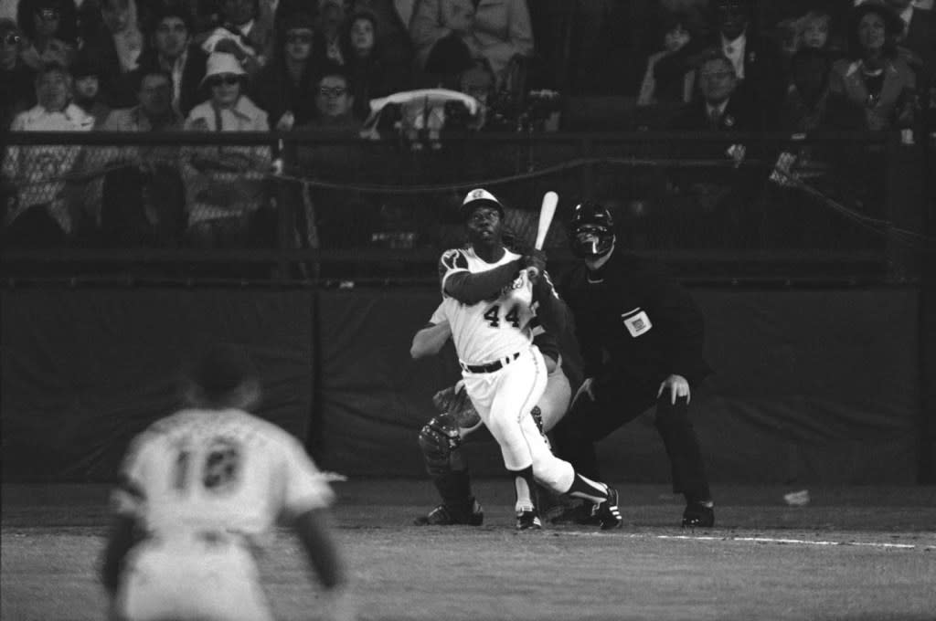 Atlanta Braves’ Hank Aaron eyes the flight of the ball after hitting his 715th career homer in a game against the Los Angeles Dodgers in Atlanta, Ga., Monday night, April 8, 1974. (AP Photo/Harry Harris, File)