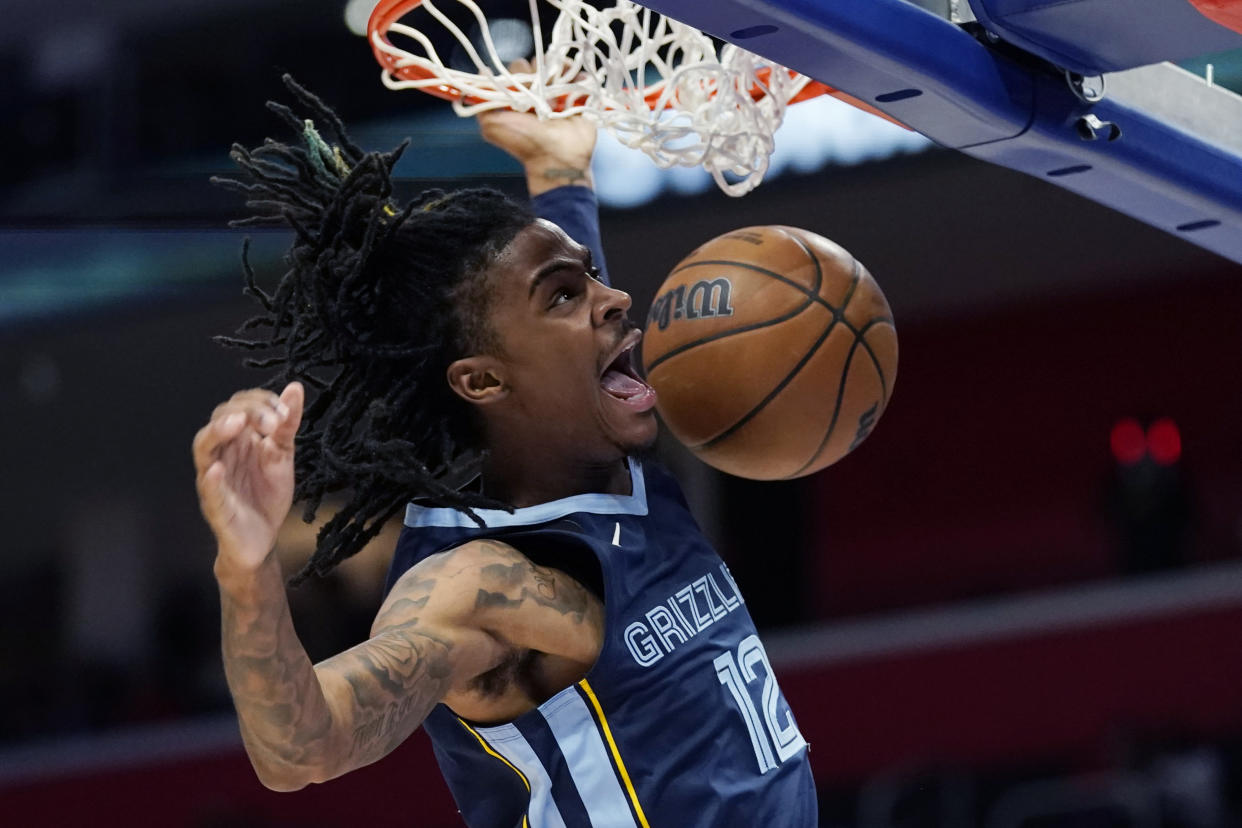 Memphis Grizzlies guard Ja Morant dunks during the second half of an NBA preseason basketball game against the Detroit Pistons, Thursday, Oct. 13, 2022, in Detroit. (AP Photo/Carlos Osorio)