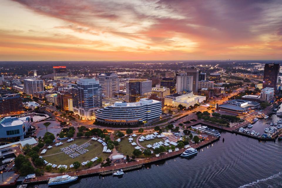 Norfolk, Virginia, downtown city skyline from over the Elizabeth River at dusk.