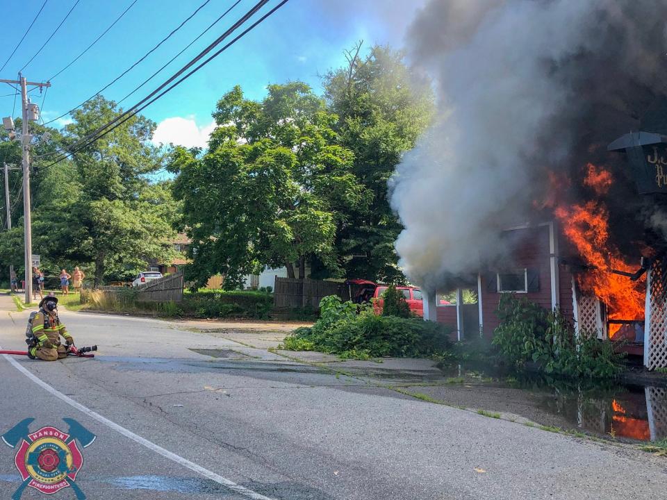 Firefighters battle a three-alarm blaze at the former JJ's Pub, at 16 Liberty St. in Hanson, on July 6, 2018.