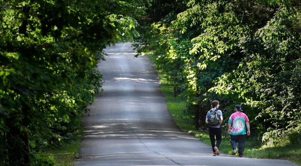 Walkers enjoy strolling down a road inside Cedars of Lebanon State Park in Lebanon, Tenn.