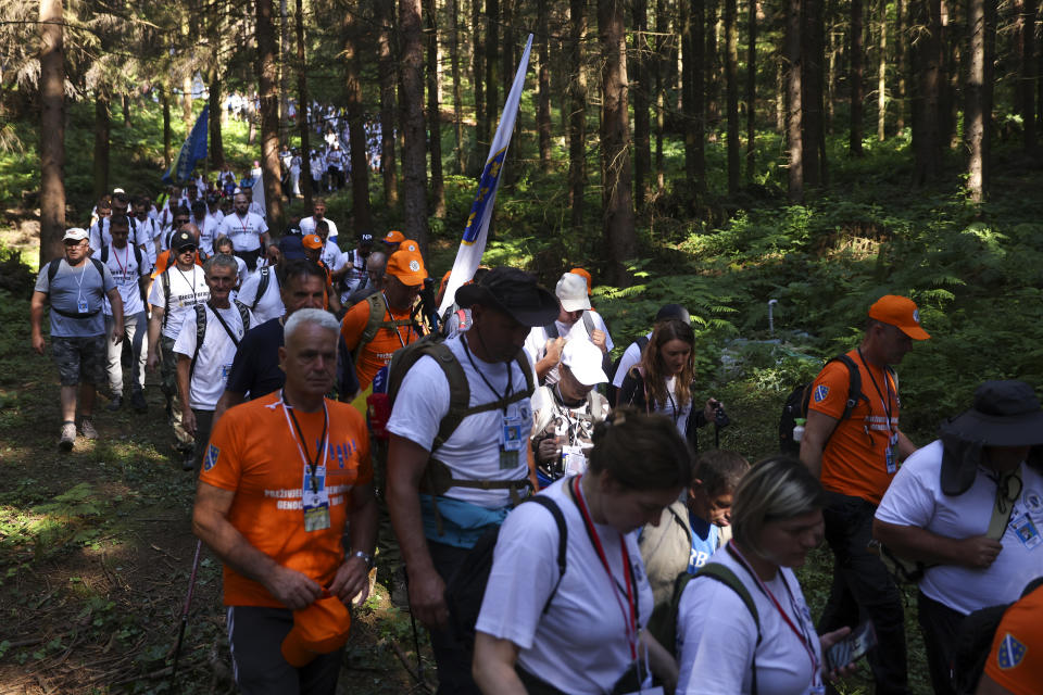 Participants in the "March of Peace", march in memory of the 1995 Srebrenica massacre, in Nezuk, Bosnia, Saturday, July 8, 2023. A solemn peace march started on Saturday through forests in eastern Bosnia in memory of the 1995 Srebrenica massacre, Europe's only acknowledged genocide since World War II. The 100-kilometre (60-mile) march traces a route taken by Bosniak men and boys as they tried to flee Srebrenica after it was captured by Bosnian Serb forces in the closing days of the country's interethnic war in the 1990s. (AP Photo/Armin Durgut)