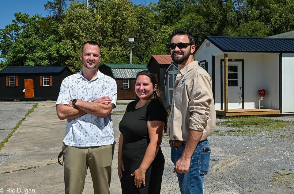 Hub City Structures owner Mark Duvall, left, Sales Manager Jessica Posey, and Samuel Sponaugle, Regional Sales Representative for Secure Storage Sheds are shown outside the new business at 1450 S. Potomac St. in Hagerstown.