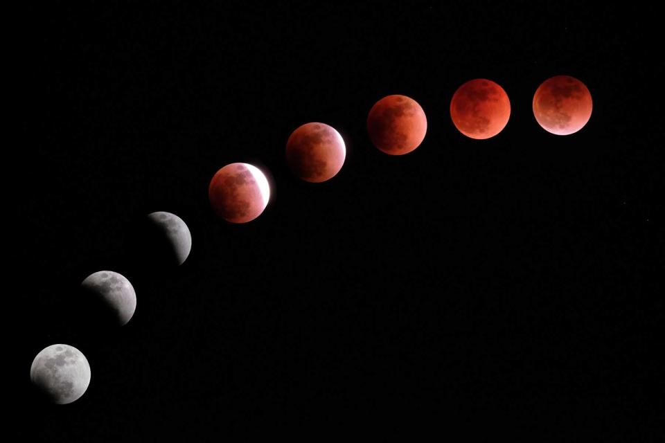 This composite image created on January 31, 2018 shows the moon during a lunar eclipse referred to as the "super blue blood moon" in Tokyo.