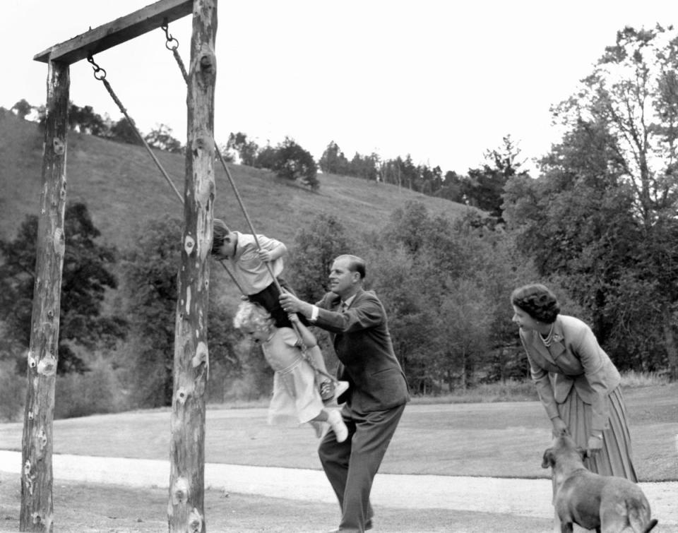 1955: The Duke pushes Prince Charles and Princess Anne on a swing at Balmoral, watched by the Queen (PA)