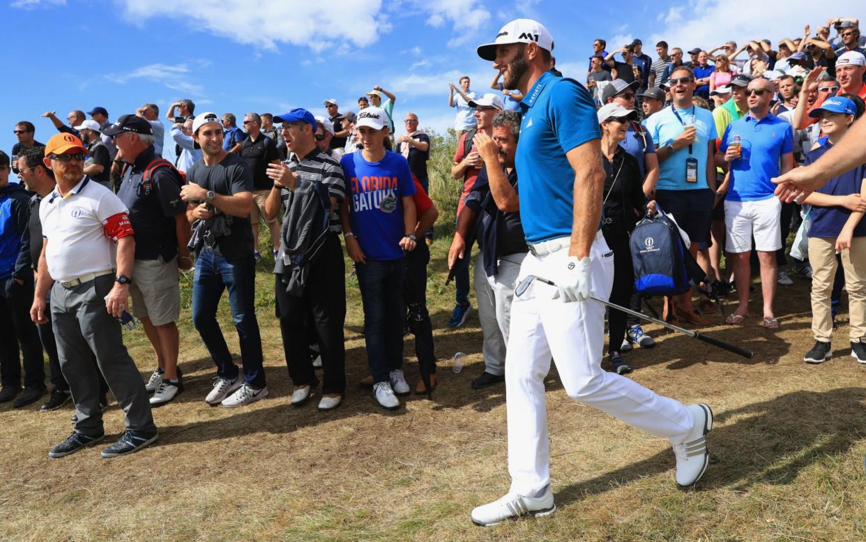 Dustin Johnson is cheered on by the crowd - Getty Images Europe