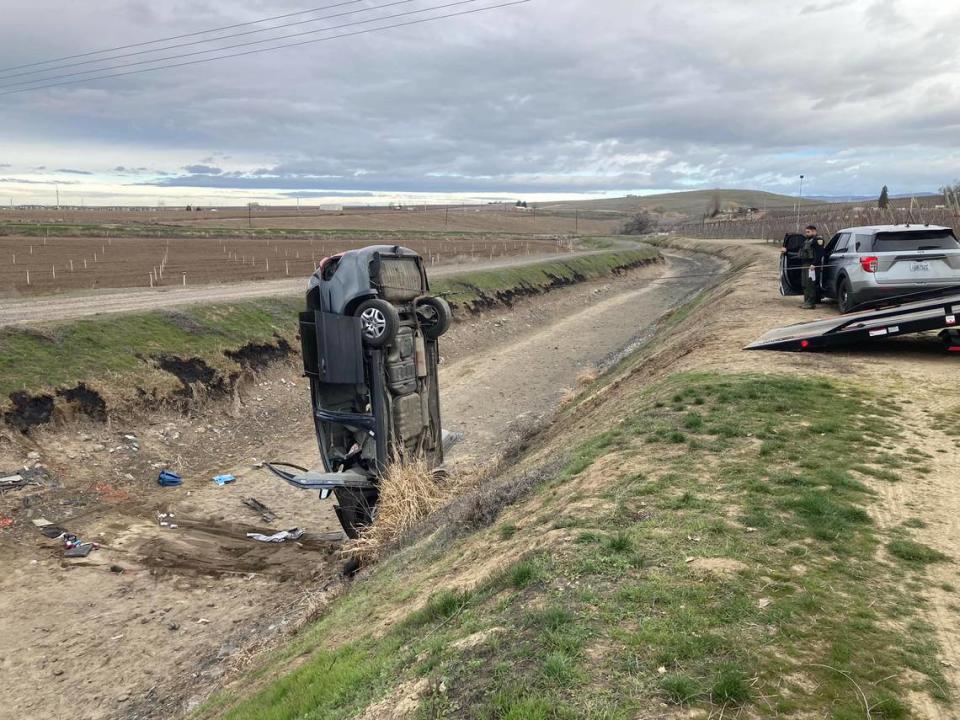 Ken’s Auto Rescue removes a minivan that overturned in a canal near Prosser.