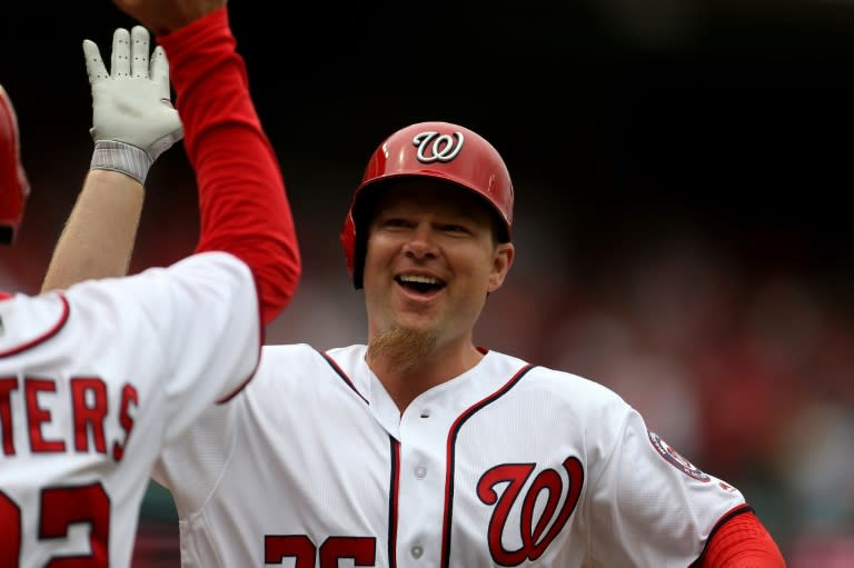 Adam Lind of the Washington Nationals celebrates after hitting a two-run home run against the Miami Marlins in the seventh inning of their opening day game, at Nationals Park in Washington, DC, on April 3, 2017