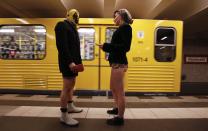 Passengers without their pants talk next to a subway train during the "No Pants Subway Ride" event at Alexanderplatz subway station in Berlin January 12, 2014. The event is an annual flash mob and occurs in different cities around the world, according to its organisers. REUTERS/Fabrizio Bensch (GERMANY - Tags: SOCIETY ENTERTAINMENT)