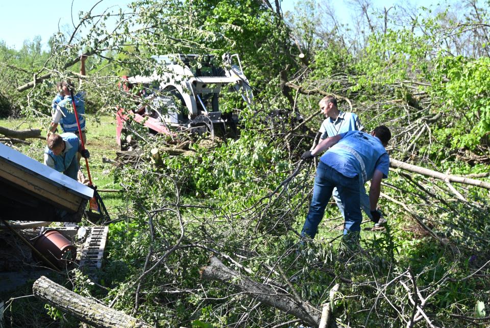 Amish and Mennonite church members came with equipment to quickly clear trees and debris left by the May 7 tornado in Sherwood Township.