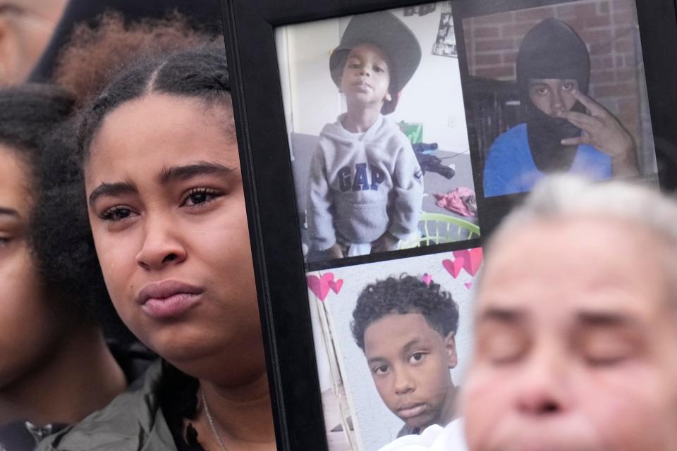 Makayla Nichols, sister of Sinzae Reed, holds a picture frame with photos of him during a community press event in Columbus, Ohio, on Jan. 1, 2023.