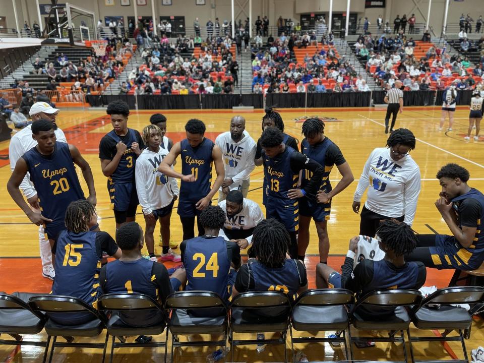 UPrep coach Jerice Crouch, center, talks to his team during a timeout of the NYSPHSAA Class AAA region final on Friday, March 8, 2024 at Buffalo State University. UPrep lost to Section VI's Niagara Falls 54-48.