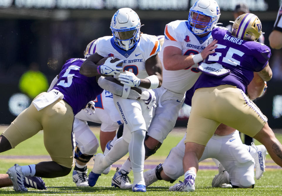 Boise State running back Ashton Jeanty (2) rushes against Washington linebacker Edefuan Ulofoshio (5) during the first half of an NCAA college football game, Saturday, Sept. 2, 2023, in Seattle. (AP Photo/Lindsey Wasson)