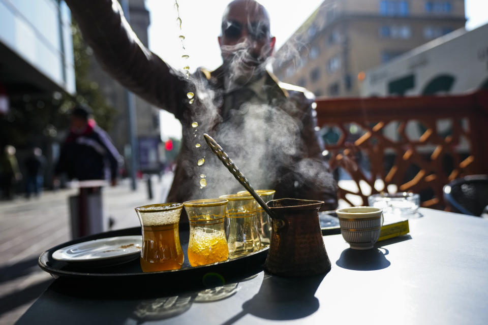 Steam rises from servings of Moroccan tea at an outdoor restaurant, in Santiago, Chile, Friday, May 17, 2024. Bitter cold is gripping Chile, a country that doesn't usually experience frost and wind chills this time of year. (AP Photo/Esteban Felix)