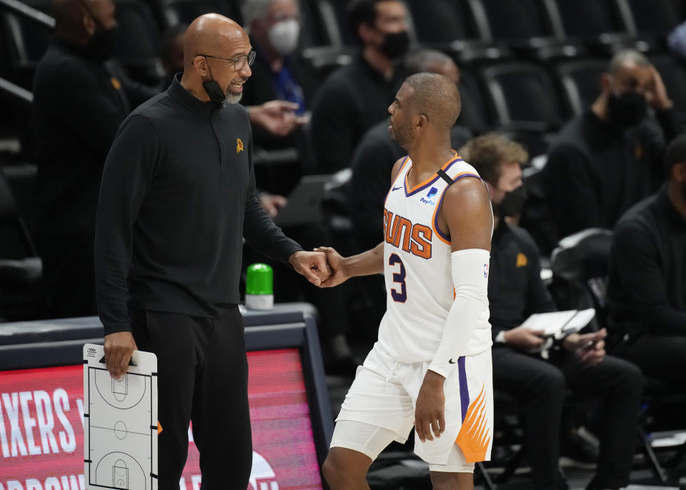 Phoenix Suns head coach Monty Williams, left, congratulates guard Chris Paul late in the second half of Game 4 of an NBA second-round playoff series against the Denver Nuggets, Sunday, June 13, 2021, in Denver. Phoenix won 125-118 to sweep the series. (AP Photo/David Zalubowski)