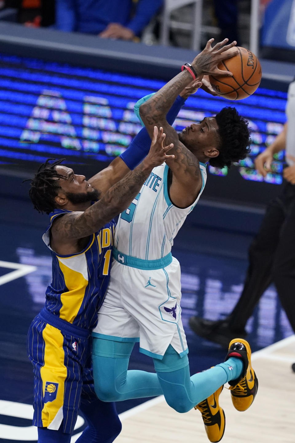 Charlotte Hornets' Jalen McDaniels (6) shoots over Indiana Pacers' Oshae Brissett (12) during the second half of an NBA basketball Eastern Conference play-in game Tuesday, May 18, 2021, in Indianapolis. (AP Photo/Darron Cummings)