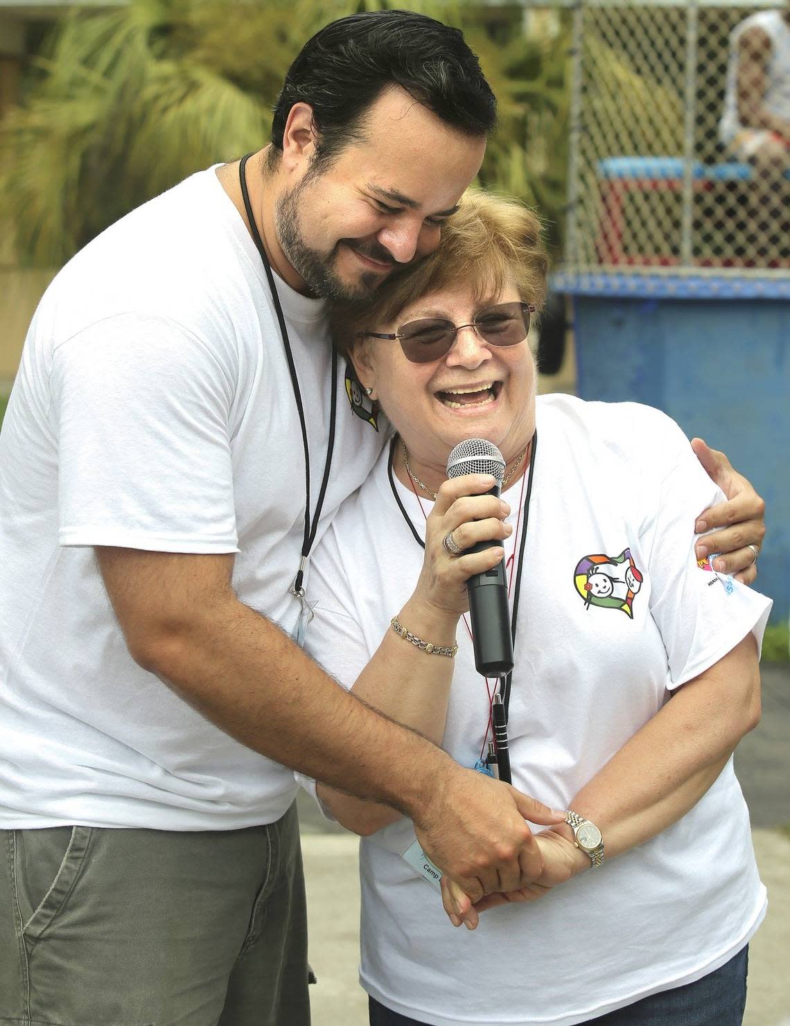 Athena Pefkarou, M.D., right, a pediatric hematologist oncologist at Nicklaus Children’s Hospital and director of Camp U.O.T.S., shares a hug with T.J. Morales on July 25, 2015. The two share a long association with the camp.