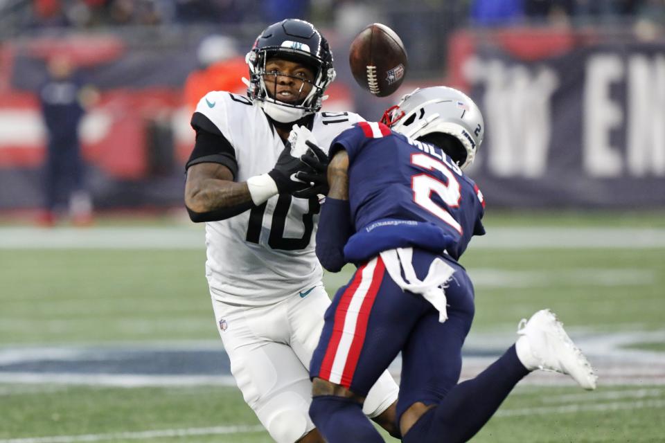 New England Patriots cornerback Jalen Mills (2) hits Jacksonville Jaguars wide receiver Laviska Shenault Jr. (10) hard, knocking the football loose, during the second half of an NFL football game, Sunday, Jan. 2, 2022, in Foxborough, Mass. (AP Photo/Paul Connors)