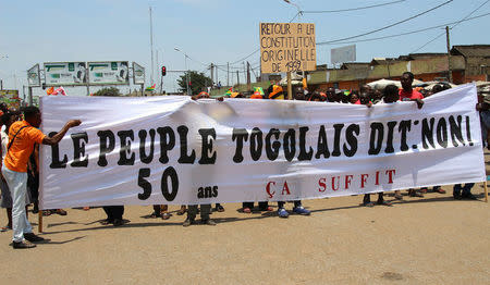 Opposition supporters take part during a protest calling for the immediate resignation of President Faure Gnassingbe in Lome, Togo, September 20, 2017. The banner reads: "Togolese people say: No. 50 years, enough". REUTERS/Stringer
