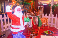 Santa with his reindeer at the entrance of Christmas Village in the Tropics.
